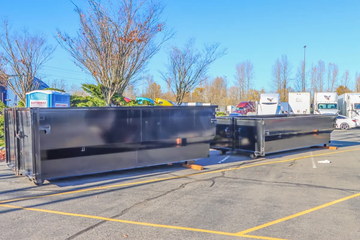 Professional dumpster rental service with roll-off container on residential driveway in Slinger